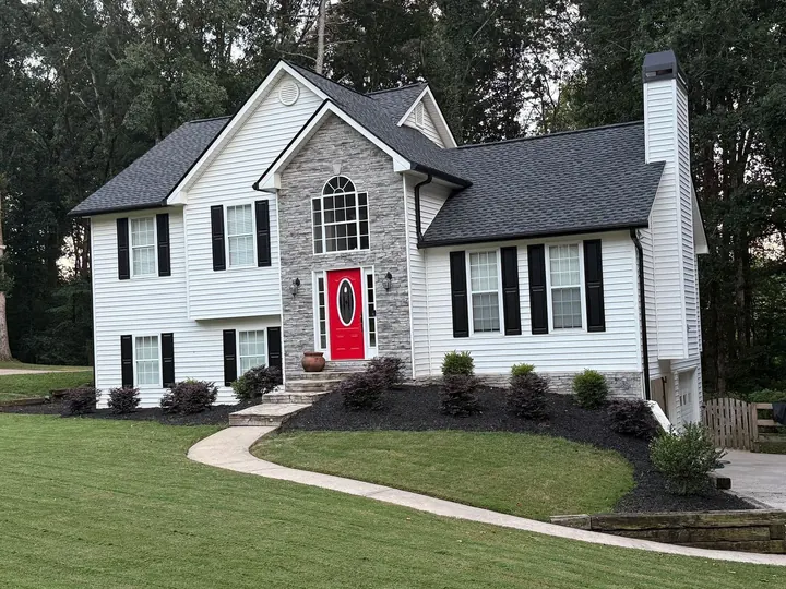 Charcoal shingle roof with gutter guards on two-story home