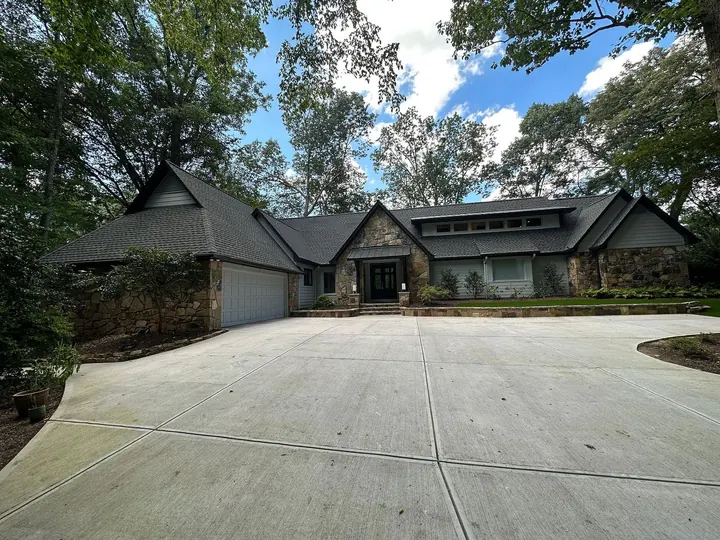 Completed roof replacement on stone and cedar home