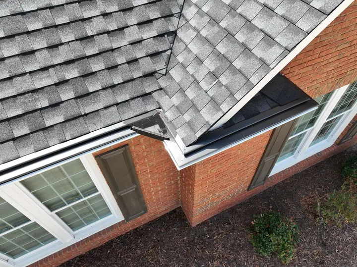 Gutter guards installed along shingle roof edge