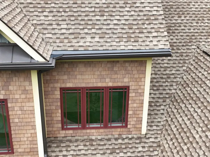 Gutter guard installation on cedar-sided home