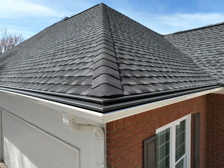 Gutter guards on brick home with new shingle roof