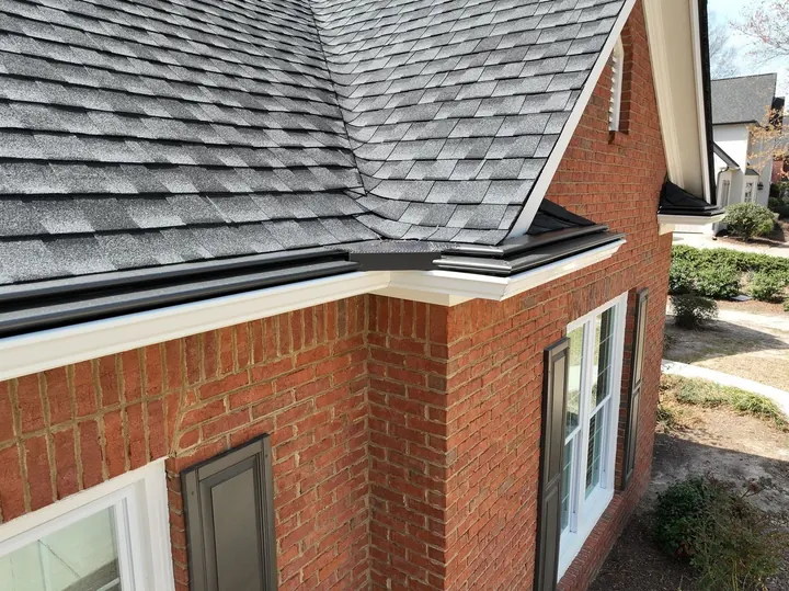 New shingles and gutter guards on brick home