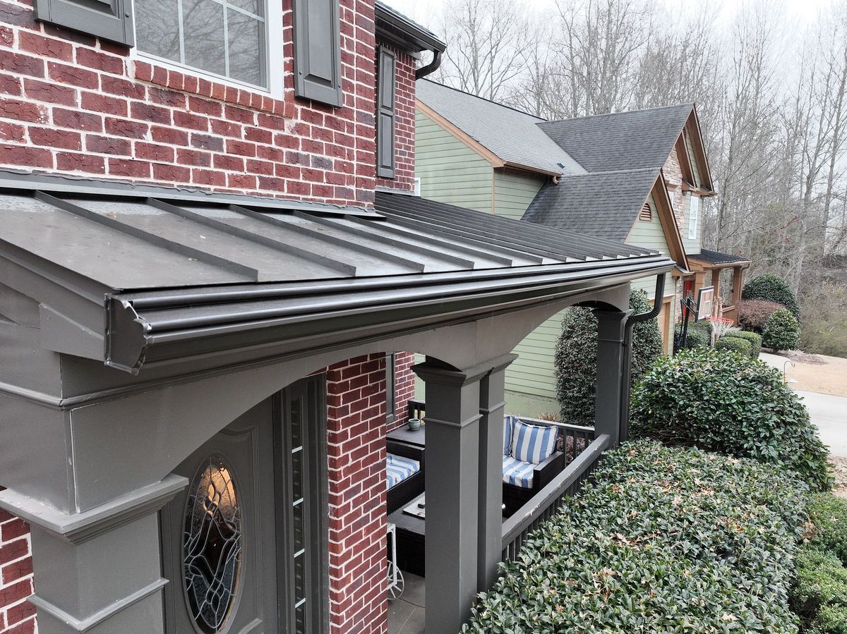 Gutter protection beneath a metal roof section