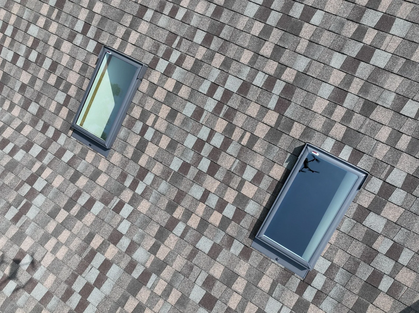 Close view of VELUX skylights and surrounding shingle installation